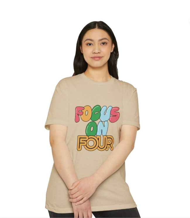 Girl wearing t-shirt. Front of shirt says "Focus on Four"